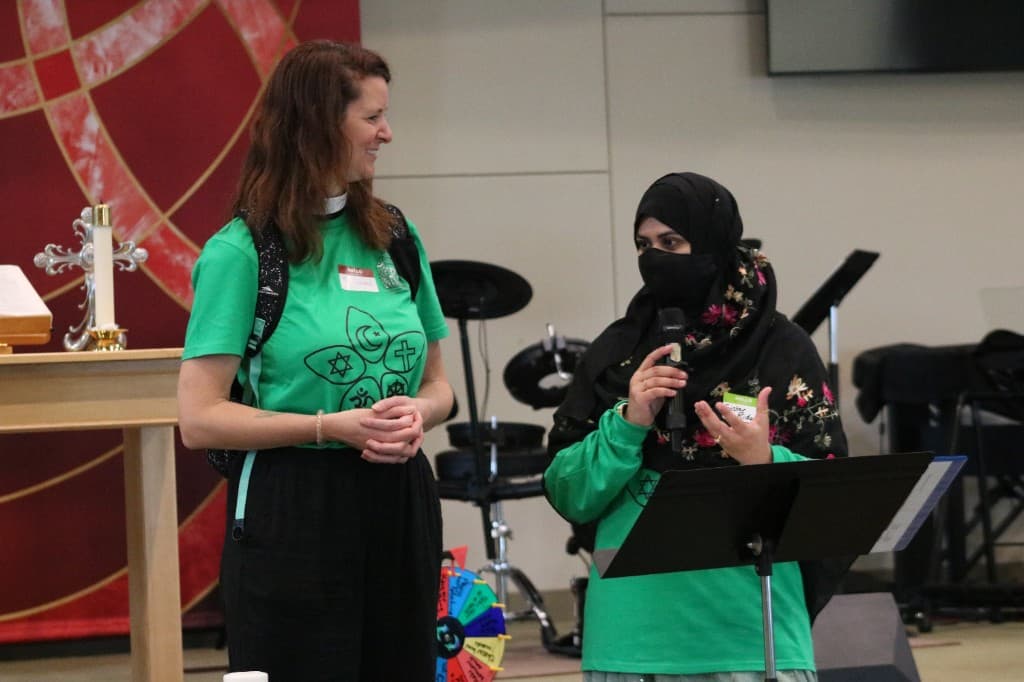 Friendship Camp leaders speaking together at an interfaith gathering